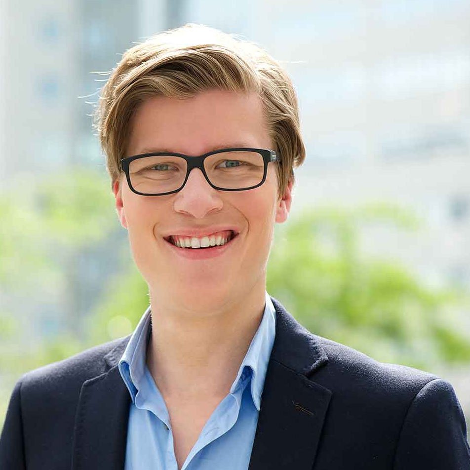 young-businessman-smiling-with-glasses2-PYEMVGR.jpg