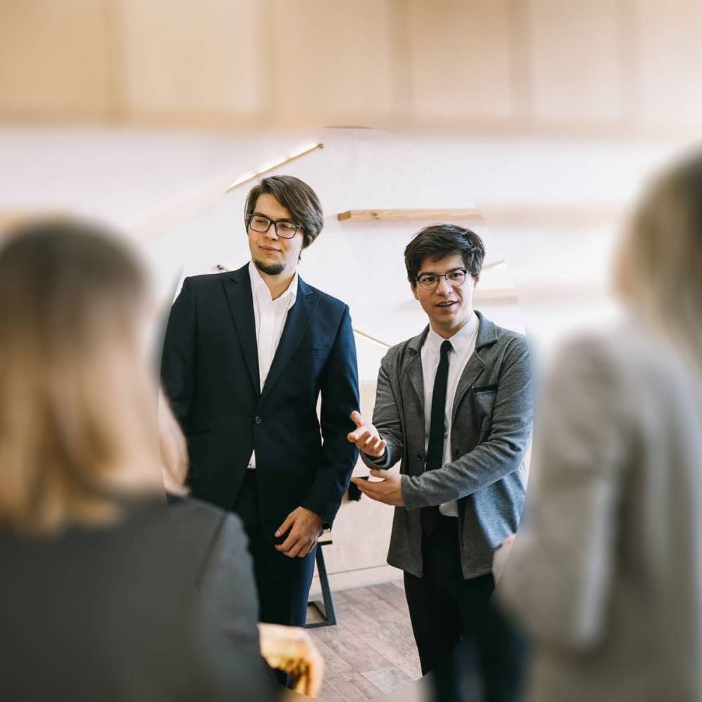 group-of-business-people-in-a-meeting-standing-gro.jpeg