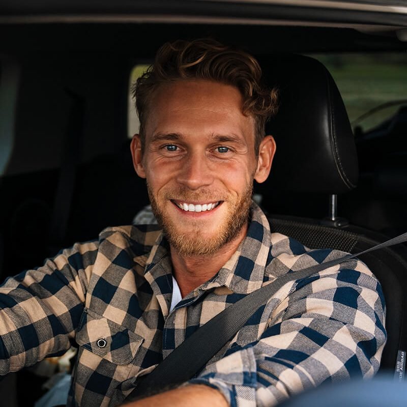 handsome-young-man-on-a-front-seat-of-car-HZ7SAS6.jpg