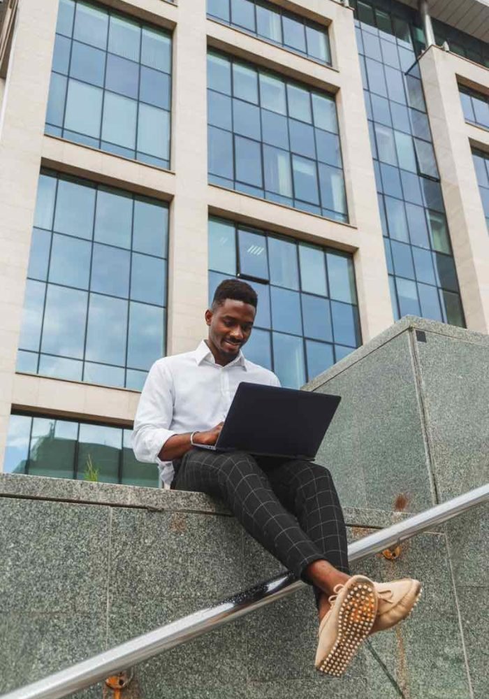 handsome-young-businessman-working-with-laptop-out-778RPJZ.jpg